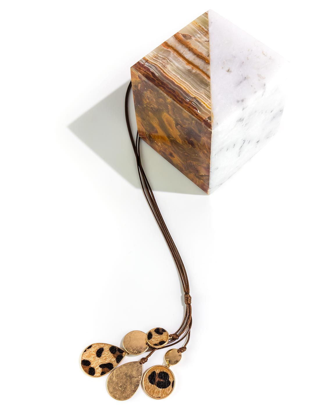 Necklace with faux fur pendants on a white surface