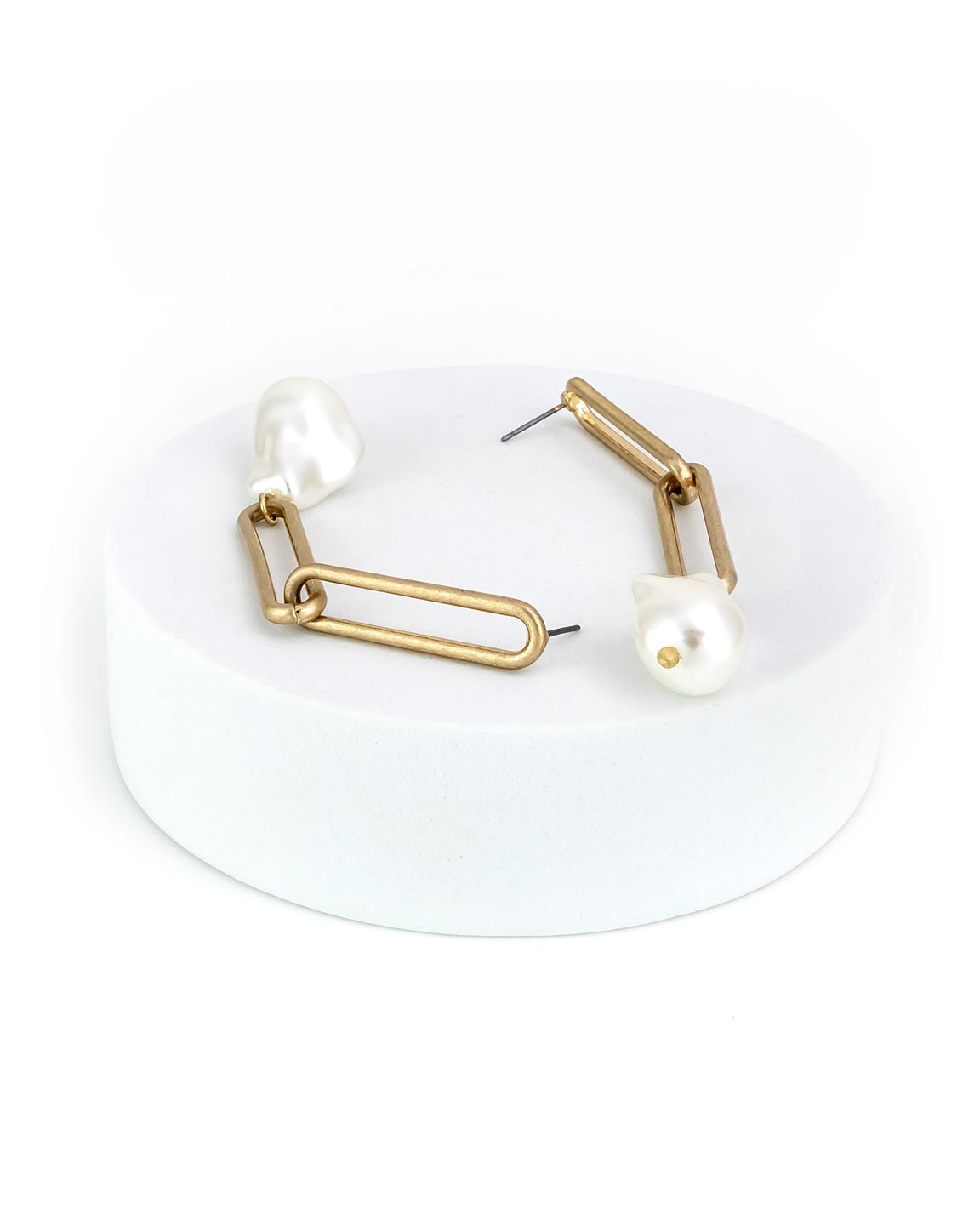 Gold drop earrings with pearl-like beads on a white background