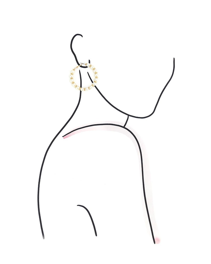 Black line drawing of a model on a white background wearing gold and pearl hoop earrings