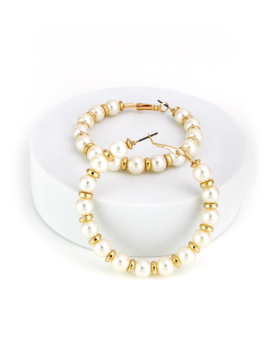Pearl and gold beaded hoop earrings on a white stand
