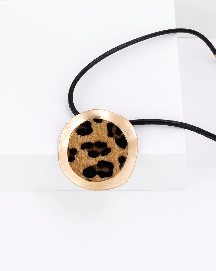 Necklace with a round pendant featuring a leopard print design on a white background