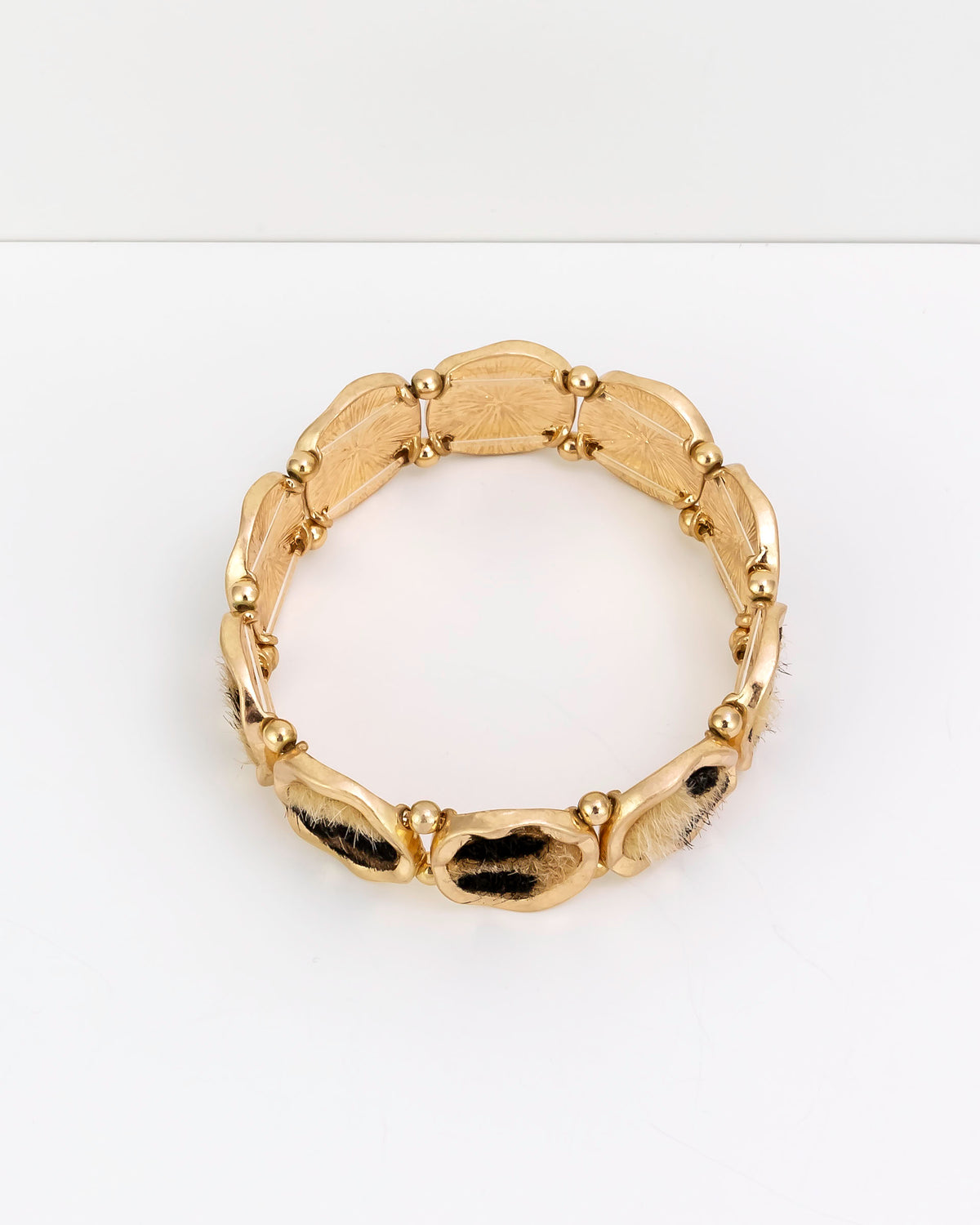 Gold bracelet on a white background