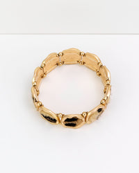 Gold bracelet on a white background