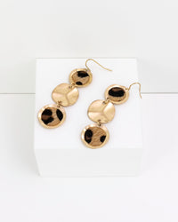 Gold and leopard faux fur earrings on a white background