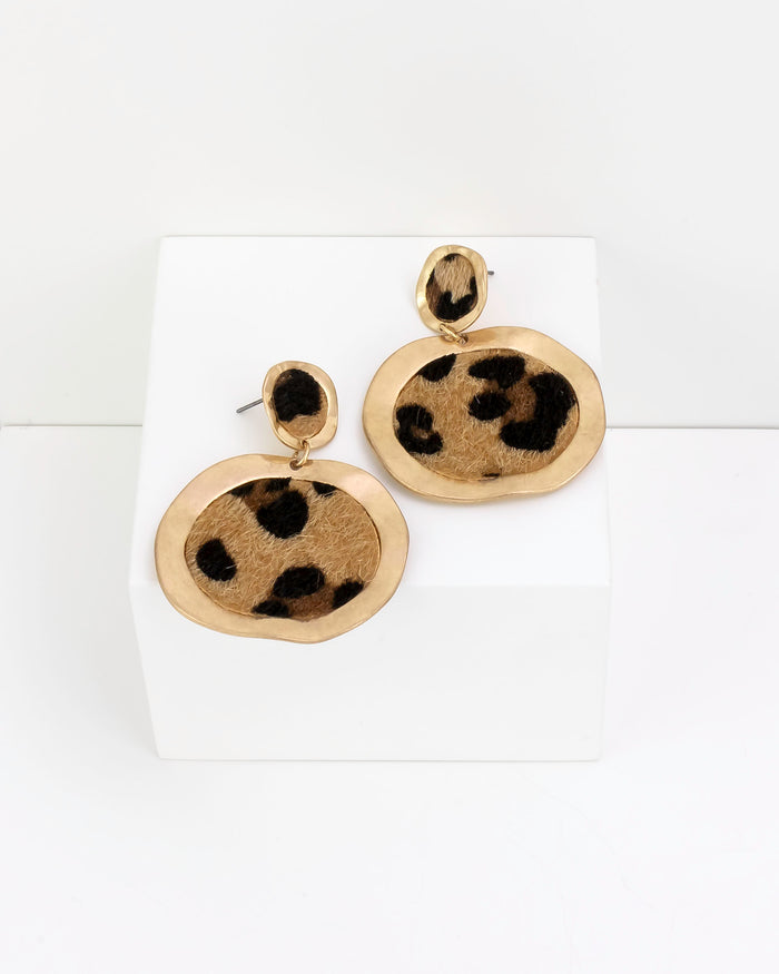 Pair of gold earrings with leopard print faux fur design on a white background