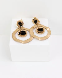 Gold drop hoop earrings with leopard faux fur print on a white background