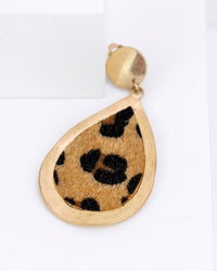 Gold teardrop-shaped pendant with leopard a faux fur print on a white background