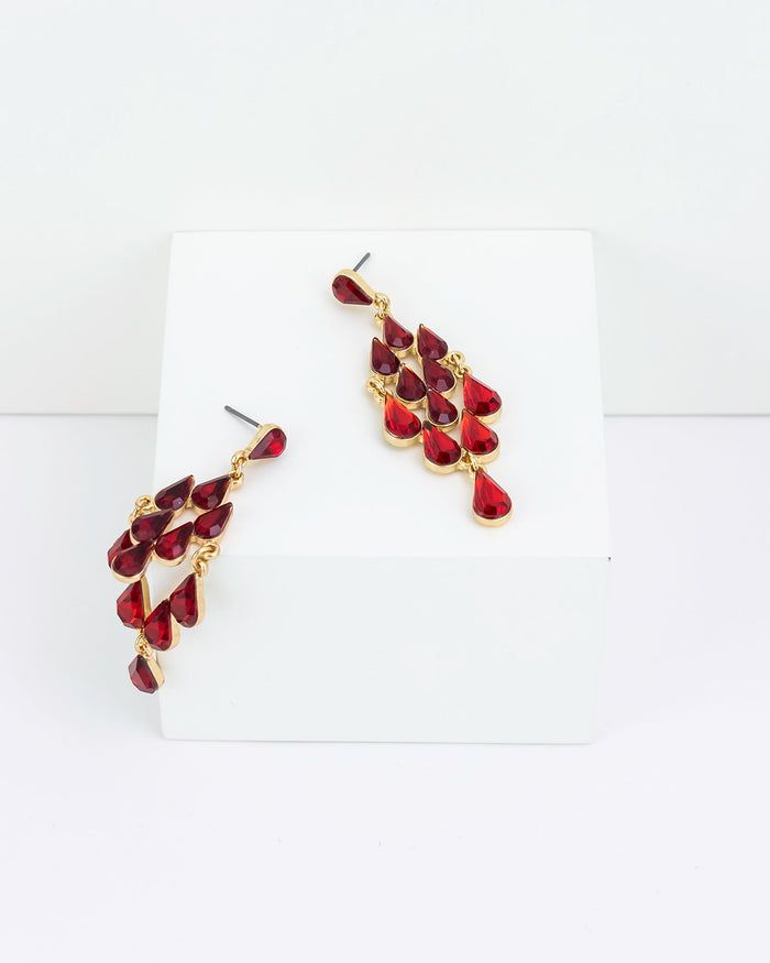 Pair of gold and red chandelier earrings on a white background