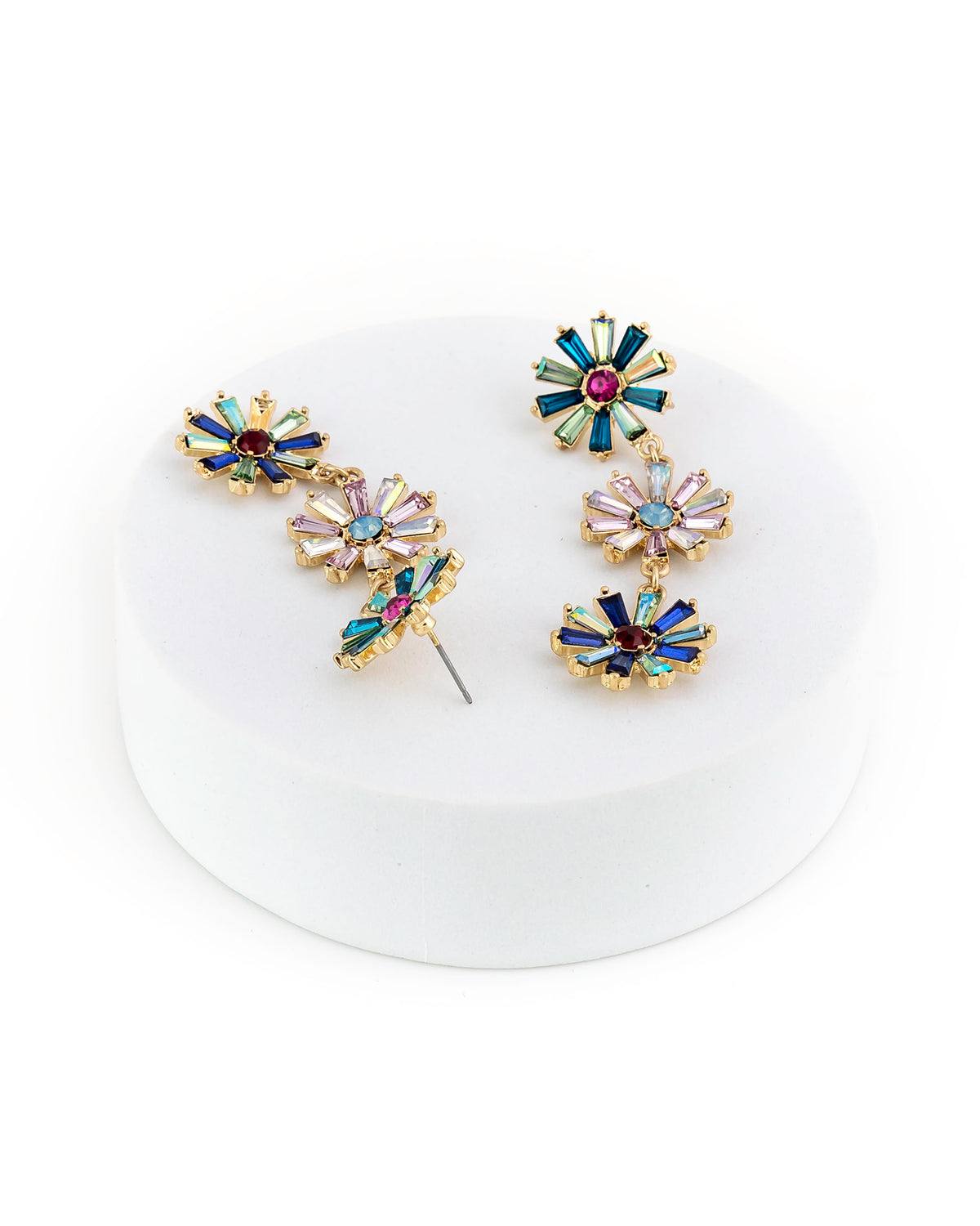 Multicolored floral earrings on a white background