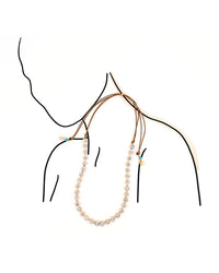 Long necklace on a mannequin with a white background
