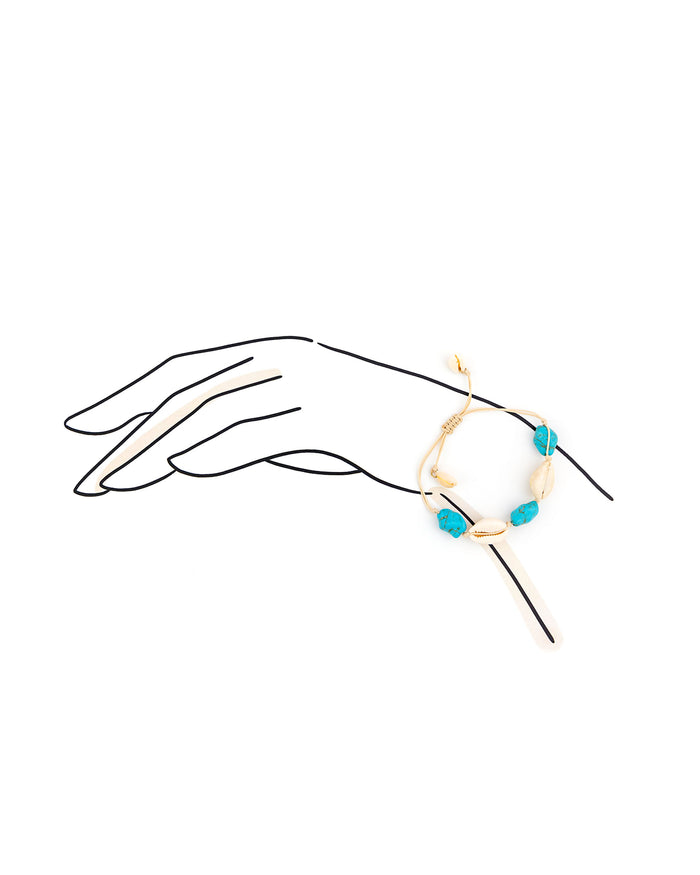 Bracelet with blue beads on a hand outline against a white background