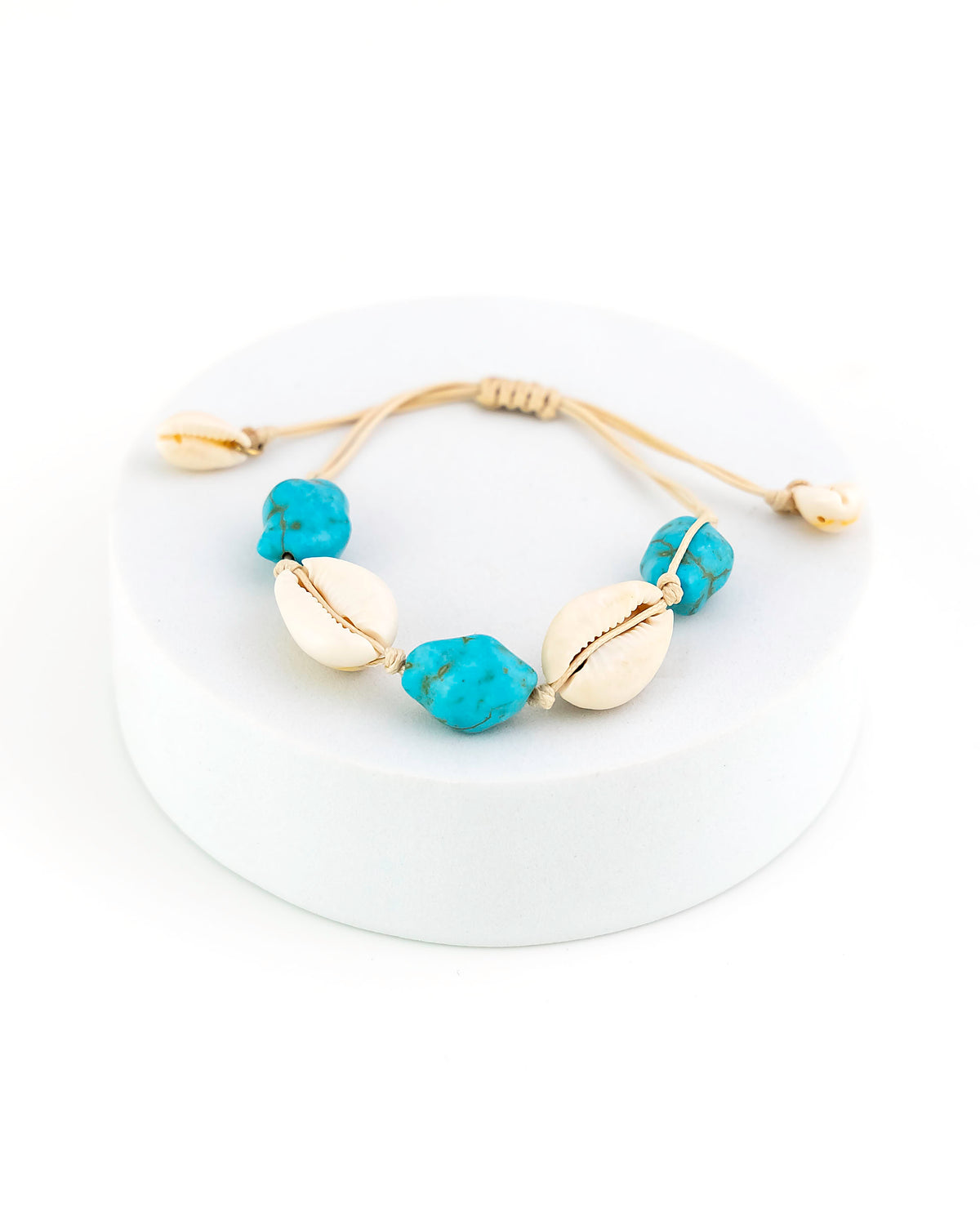 Bracelet with turq and beige beads on a white background