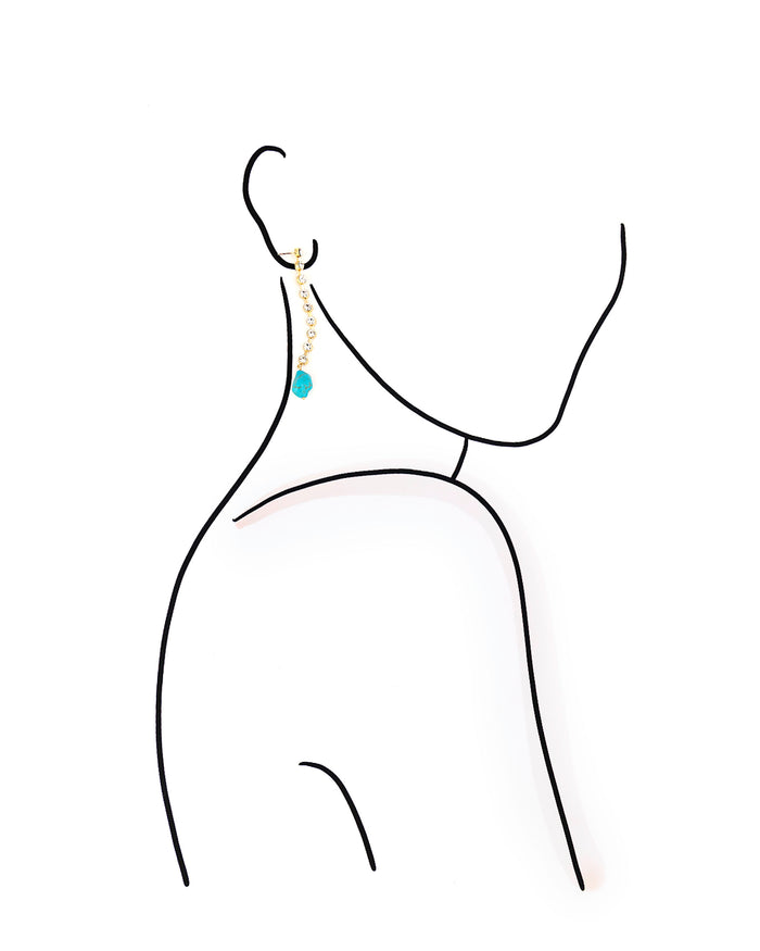 Earring with a blue gemstone on a white background