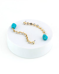 Bracelet with turq beads and gold accents on a white background