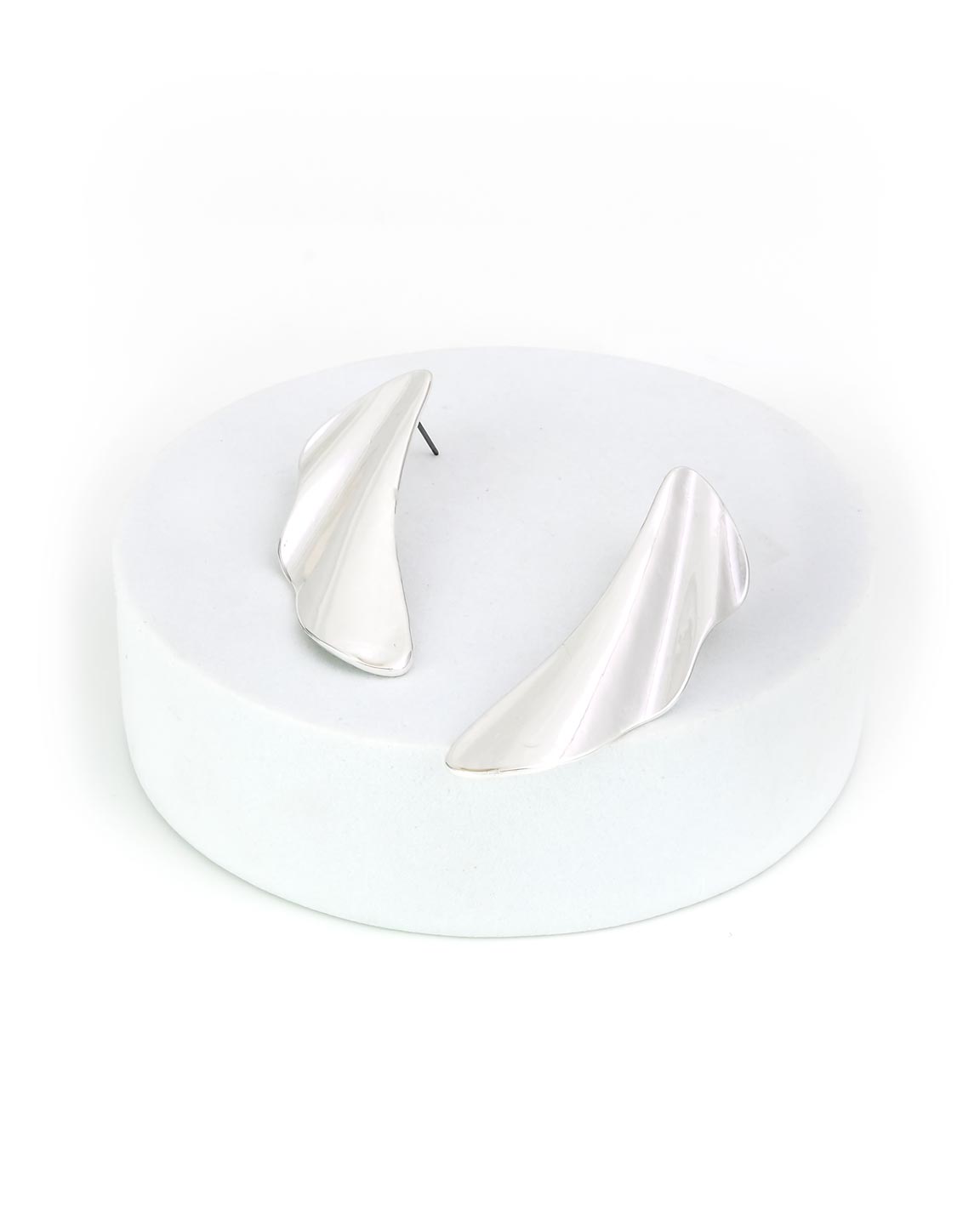 Pair of silver teardrop-shaped earrings on a white stand