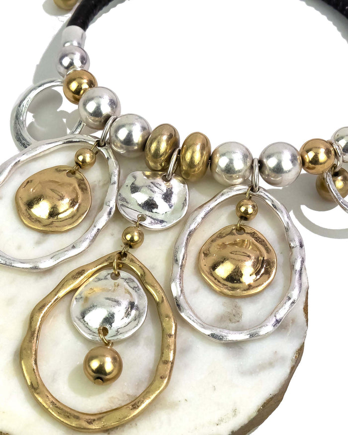 Close-up of a bracelet with gold and silver beads on a white background