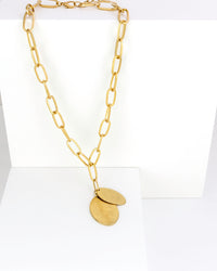 Gold chain necklace with a round pendant on a white background