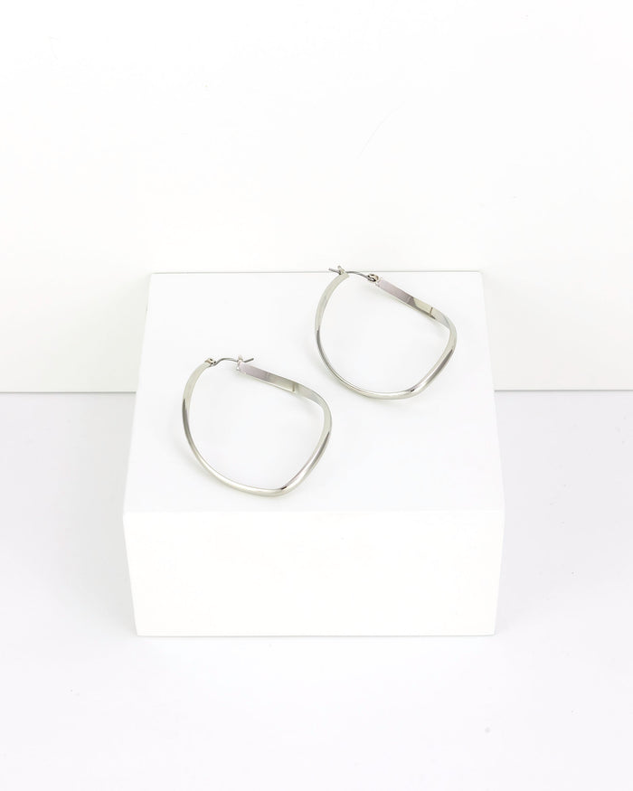 Pair of silver hoop earrings on a white background