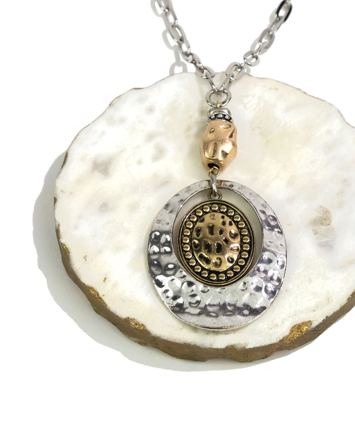 Necklace with a pendant on a white shell