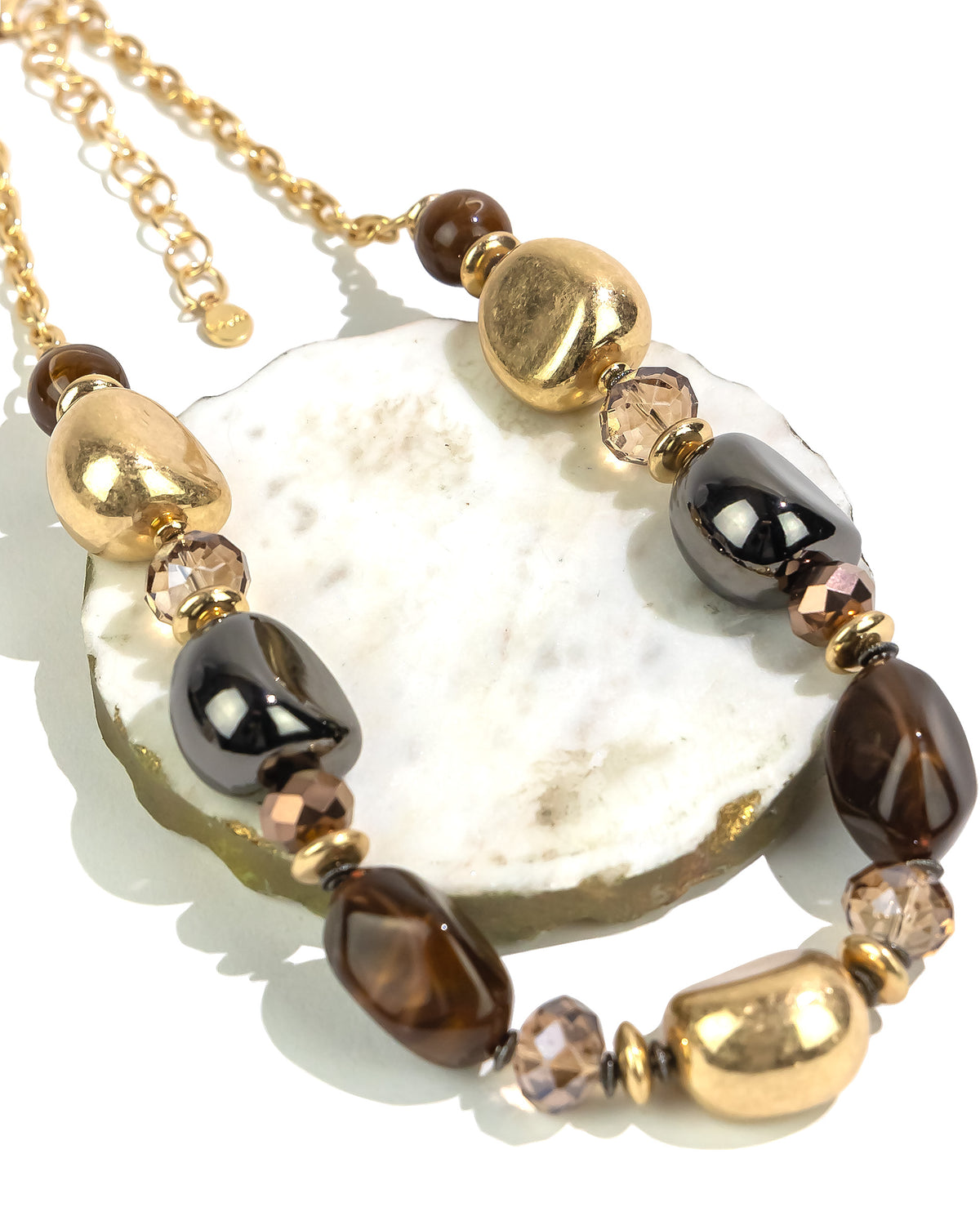 Closeup of Golden Earth Statement Necklace displayed on white background – Dauplaise Jewelry