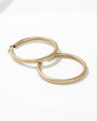 Worn Gold Tubular Hoop Earrings displayed on white background – Dauplaise Jewelry