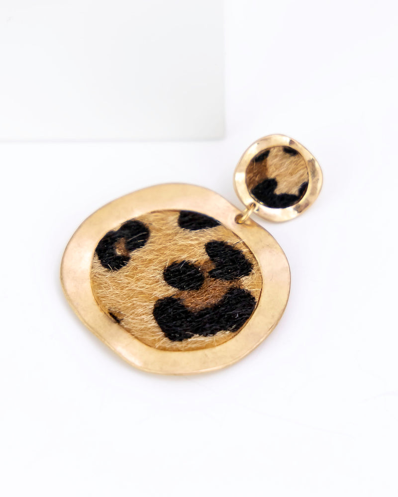 Gold and leopard print faux fur earrings on a white background