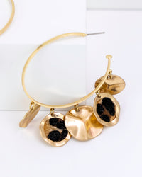 Gold hoop faux fur leopard earrings on a white background