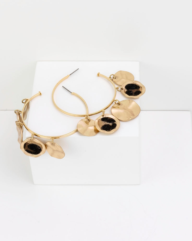 Gold hoop earrings with leopard faux fur print on a white background
