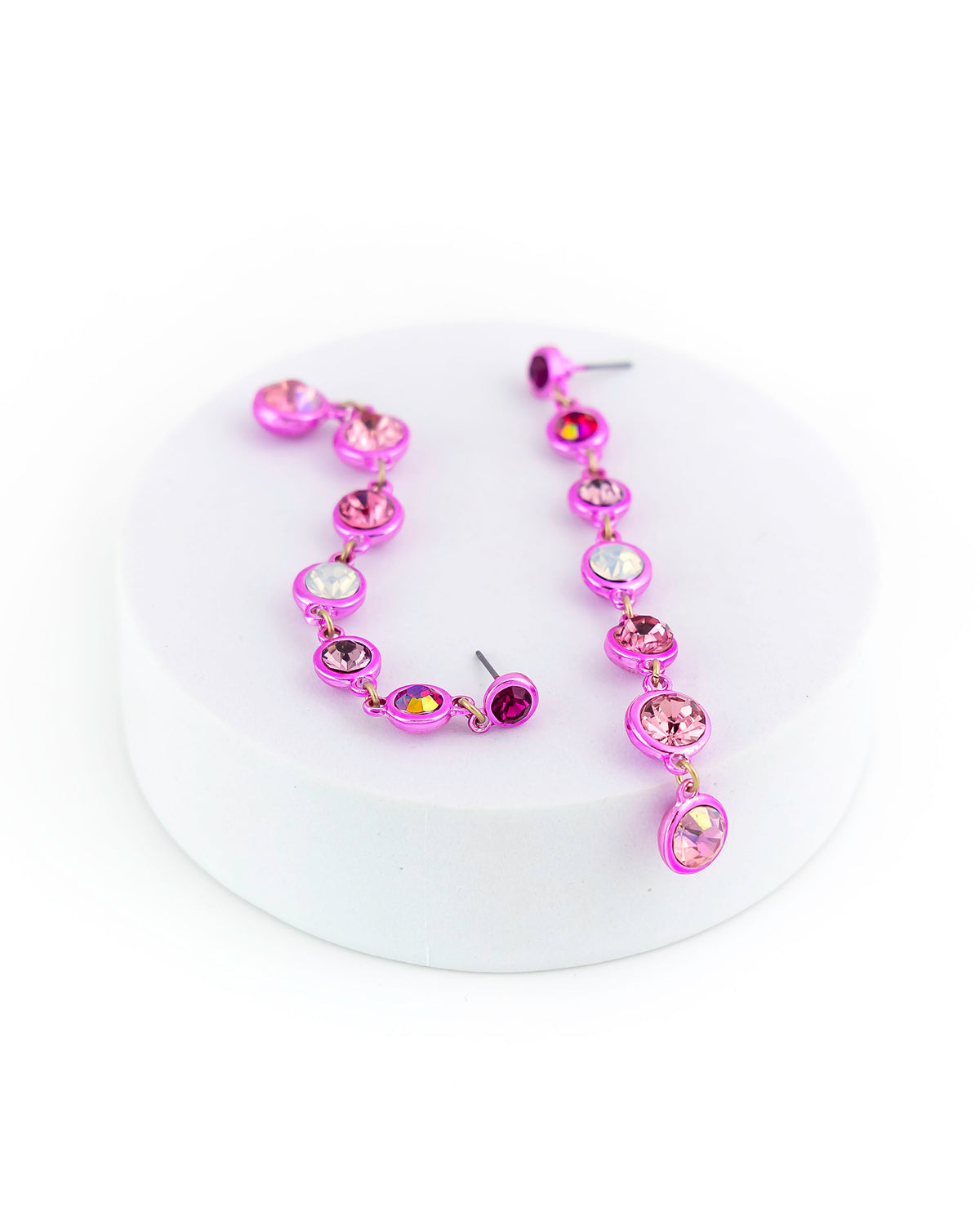 Purple necklace and earrings set on a white background