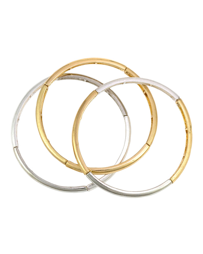 Set of three slim two-tone gold- and silver-tone segmented stretch bangles overlapping on a white background.