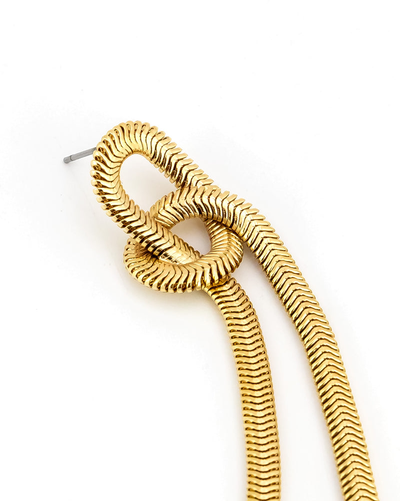 Gold earring on a white background