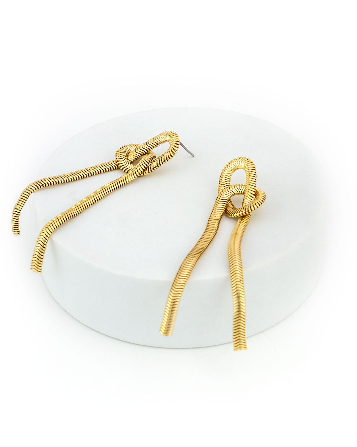 Gold spiral earrings on a white background