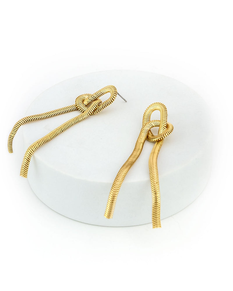 Gold spiral earrings on a white background