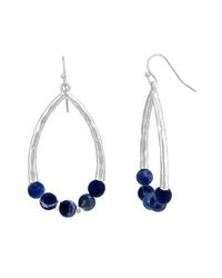 Worn-silver open teardrop French-wire earrings with deep-blue round bead accents on a white background.