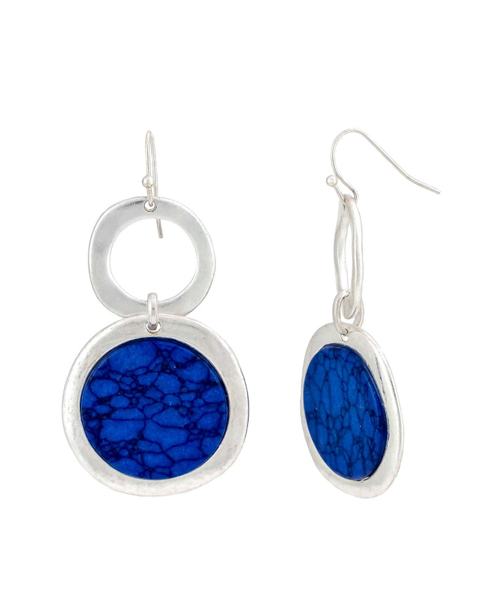 Worn-silver double ring French-wire earrings with vivid patterned blue disc accents on a white background.
