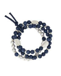 Blue three-row beaded stretch bracelet with worn-silver beads, spacers, and textured accents on a white background.