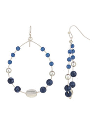 Blue beaded open hoop French-wire earrings with worn-silver accents on a white background.