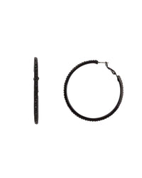 Large jet-black hoop earrings with faceted edge accents and latch-back closures on a white background.