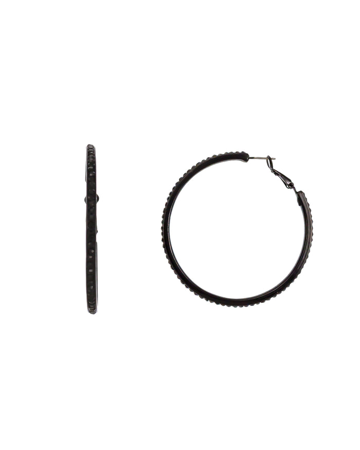 Large jet-black hoop earrings with faceted edge accents and latch-back closures on a white background.
