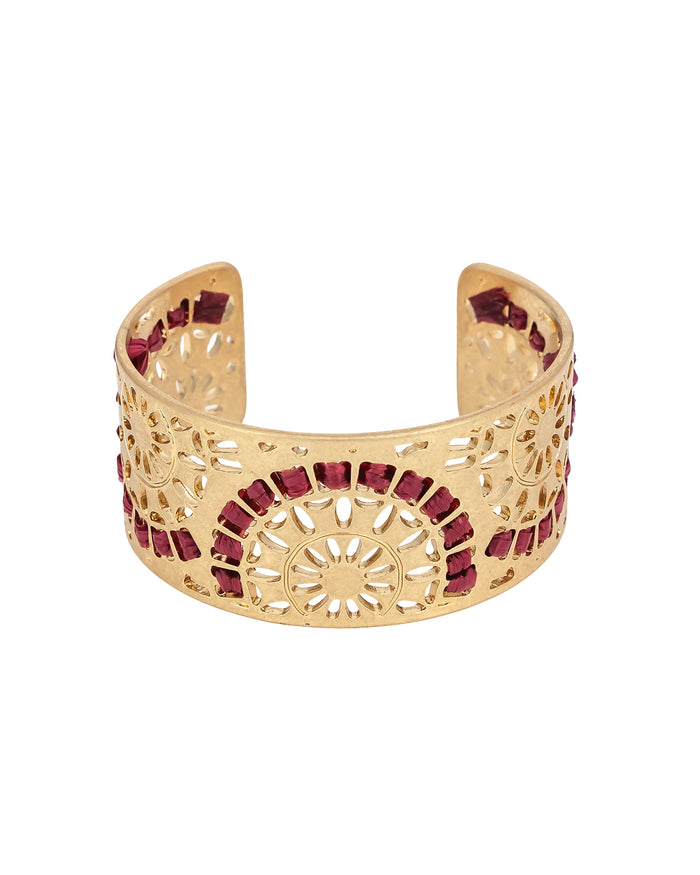 Gold bracelet with red wrapping on a white background