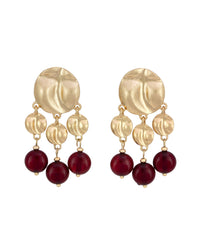 Gold earrings with red beads on a white background
