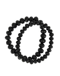 Jet-black two-row stretch bracelet with graduated faceted beads on a white background.
