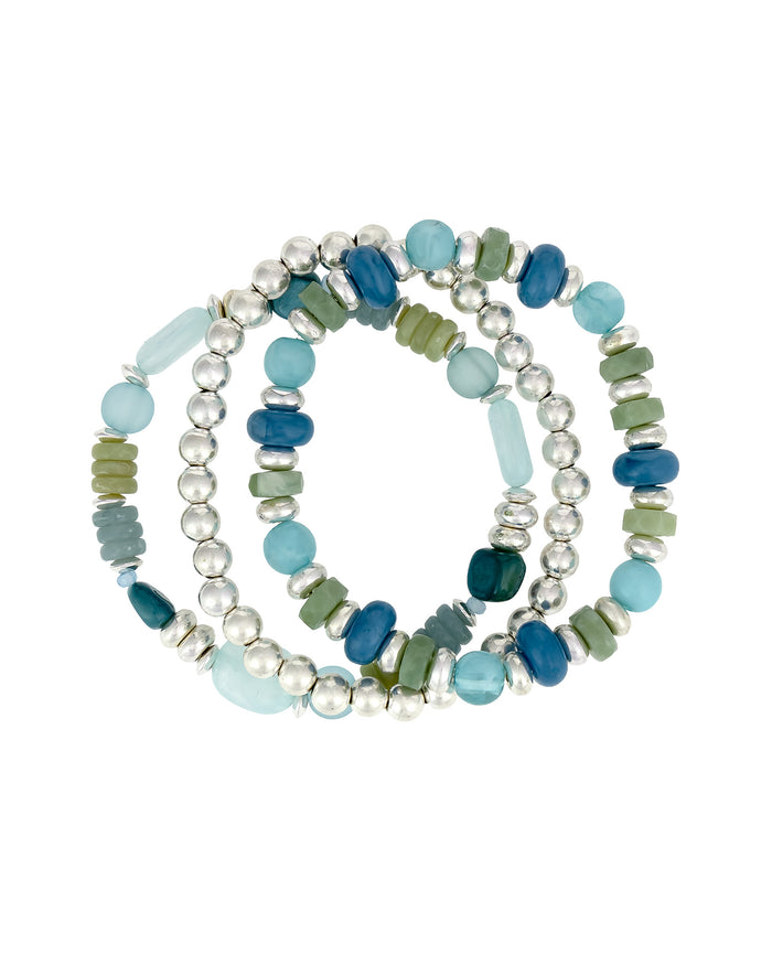 Set of three beaded bracelets in blue, green, and white on a white background