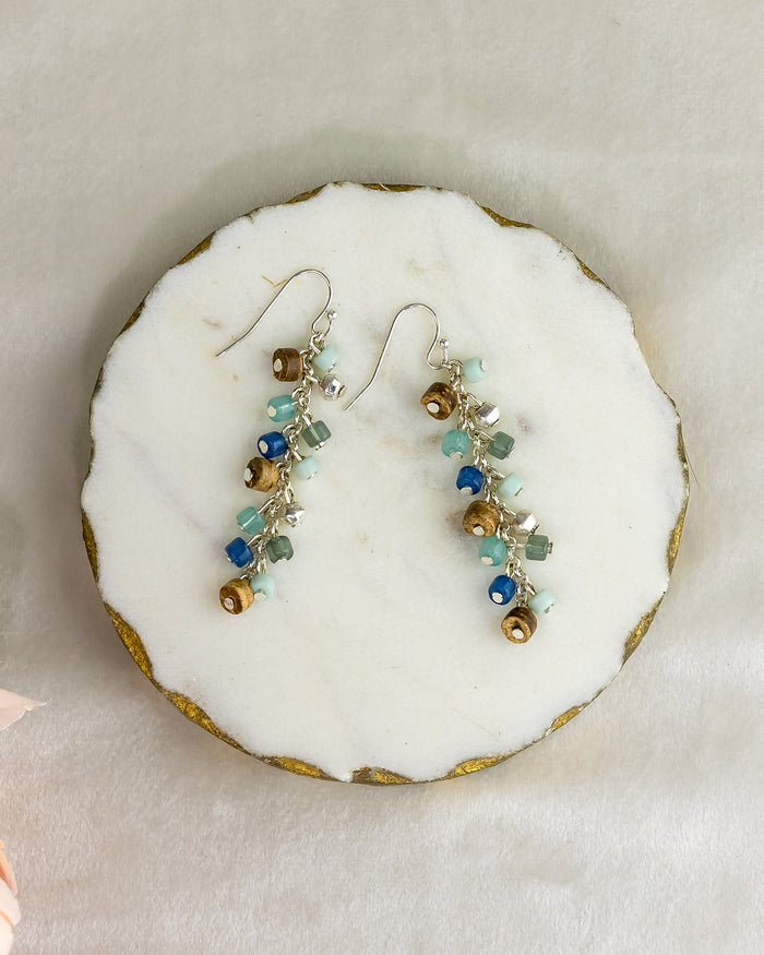 Pair of mutli-colored beaded earrings on a round white stone