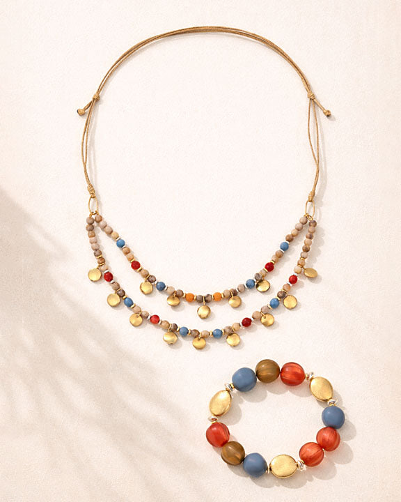 Multicolored beaded necklace and bracelet on a beige background