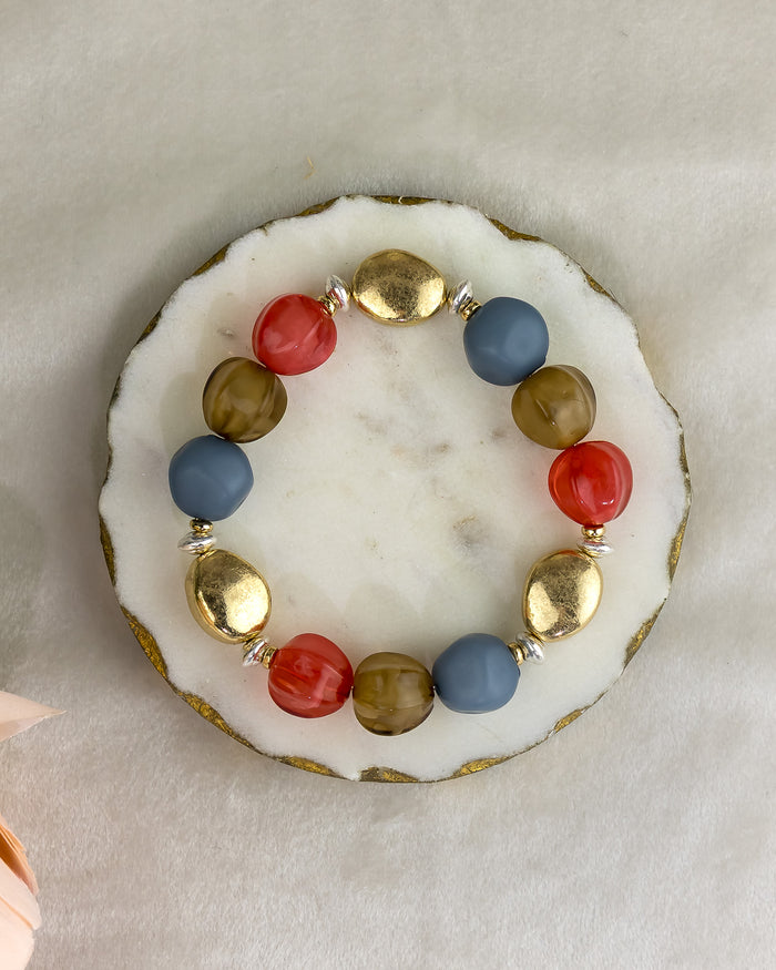 Multicolored beaded bracelet on a white stone surface