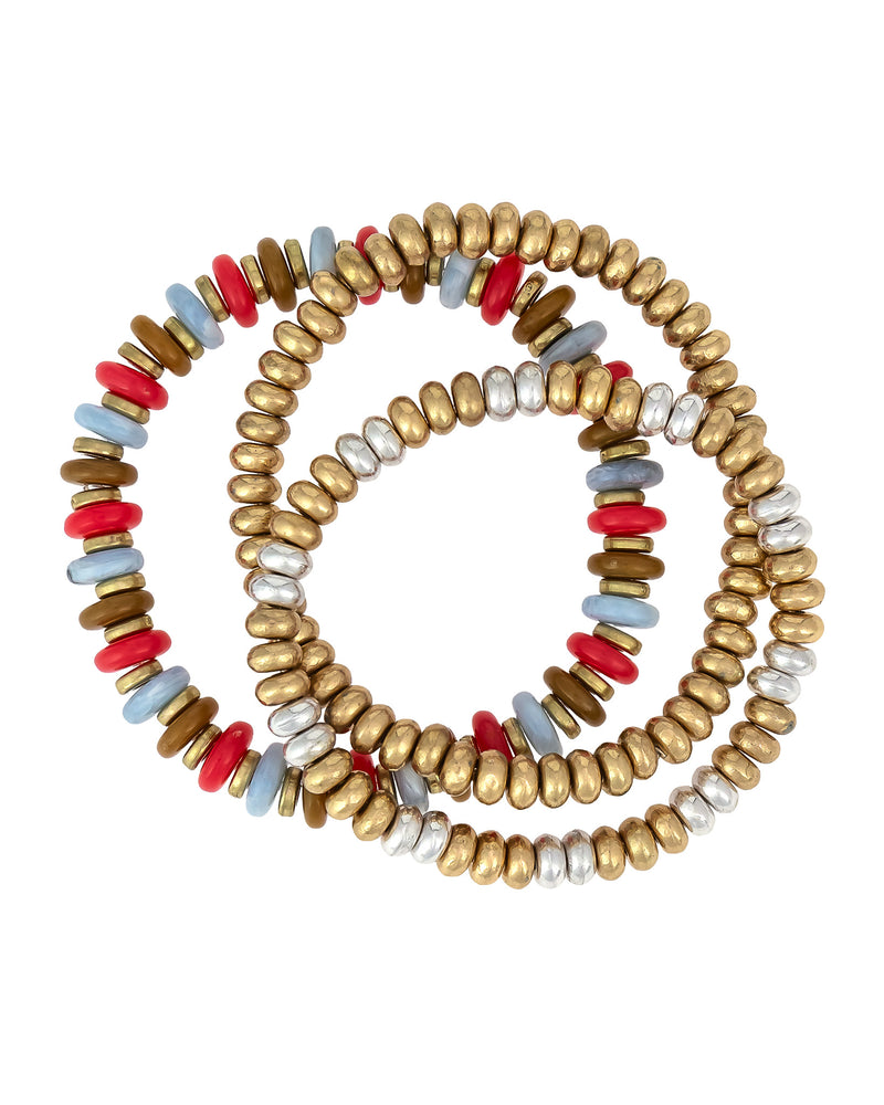 Set of three beaded bracelets with gold, red, blue, and white beads on a white background