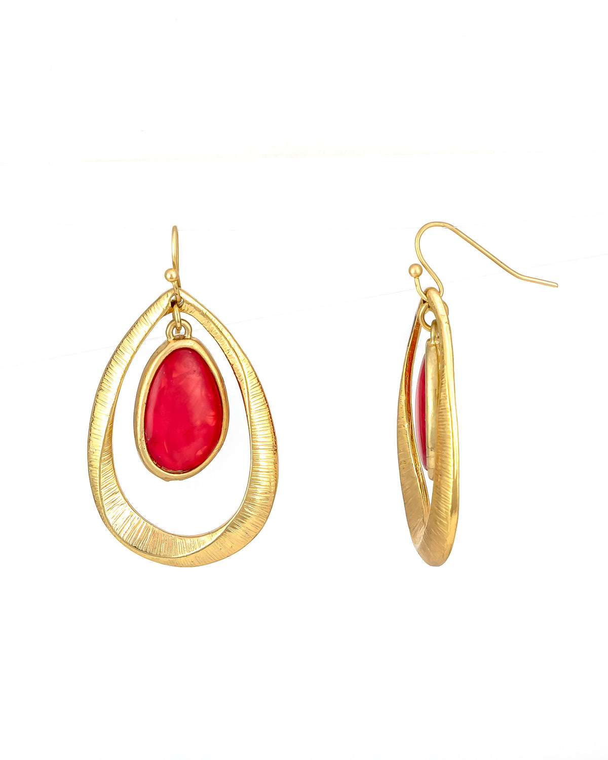 Gold earrings with coral stones on a white background