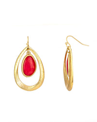Gold earrings with coral stones on a white background
