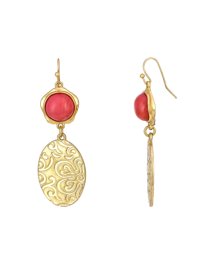 Gold earrings with red stones on a white background